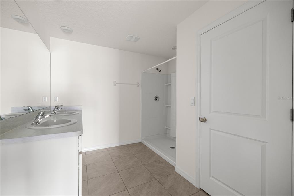 6563 Southeast 1st Loop Ocala, FL 34472 - Photo 12 of 24 a bathroom with a granite countertop sink and a mirror