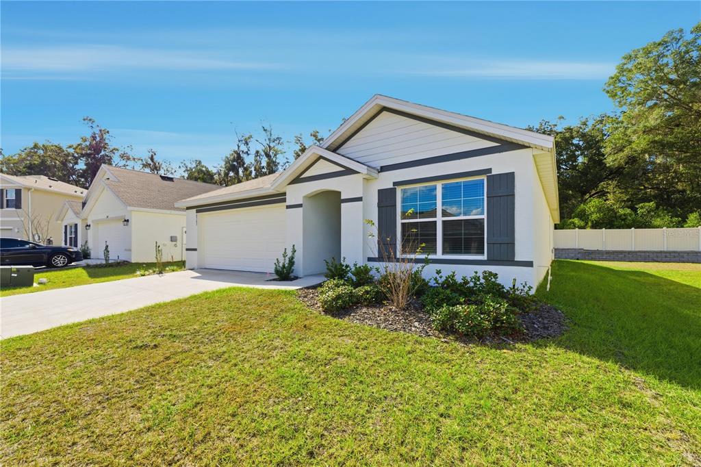6563 Southeast 1st Loop Ocala, FL 34472 - Photo 2 of 24 a house view with a garden space