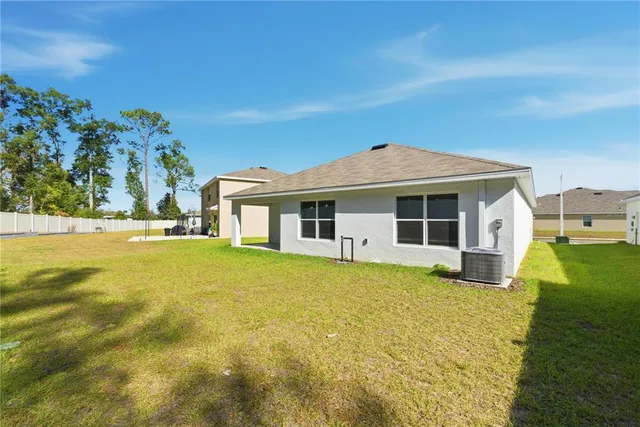 a front view of house with yard and swimming pool