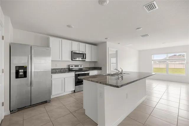 a kitchen with stainless steel appliances and white cabinets