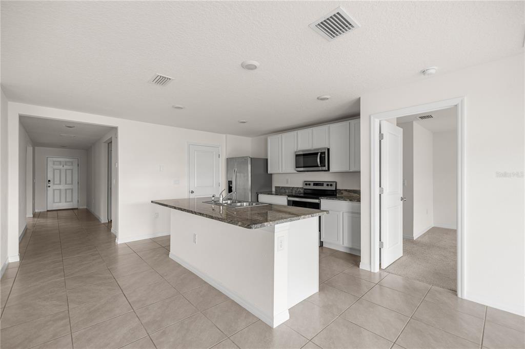 6563 Southeast 1st Loop Ocala, FL 34472 - Photo 9 of 24 a kitchen with stainless steel appliances and white cabinets