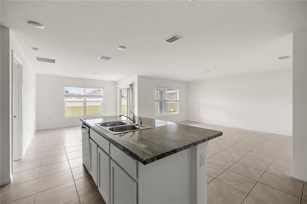 6563 Southeast 1st Loop Ocala, FL 34472 - Photo 10 of 24 a kitchen with stainless steel appliances granite countertop a sink and a stove