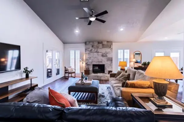 a living room with furniture kitchen view and a fireplace