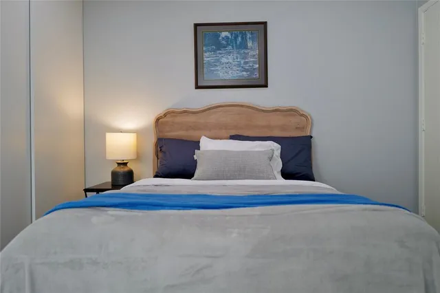 a bedroom with a bed and painting on the wall