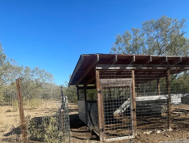 a view of a roof deck with wooden fence and a floor