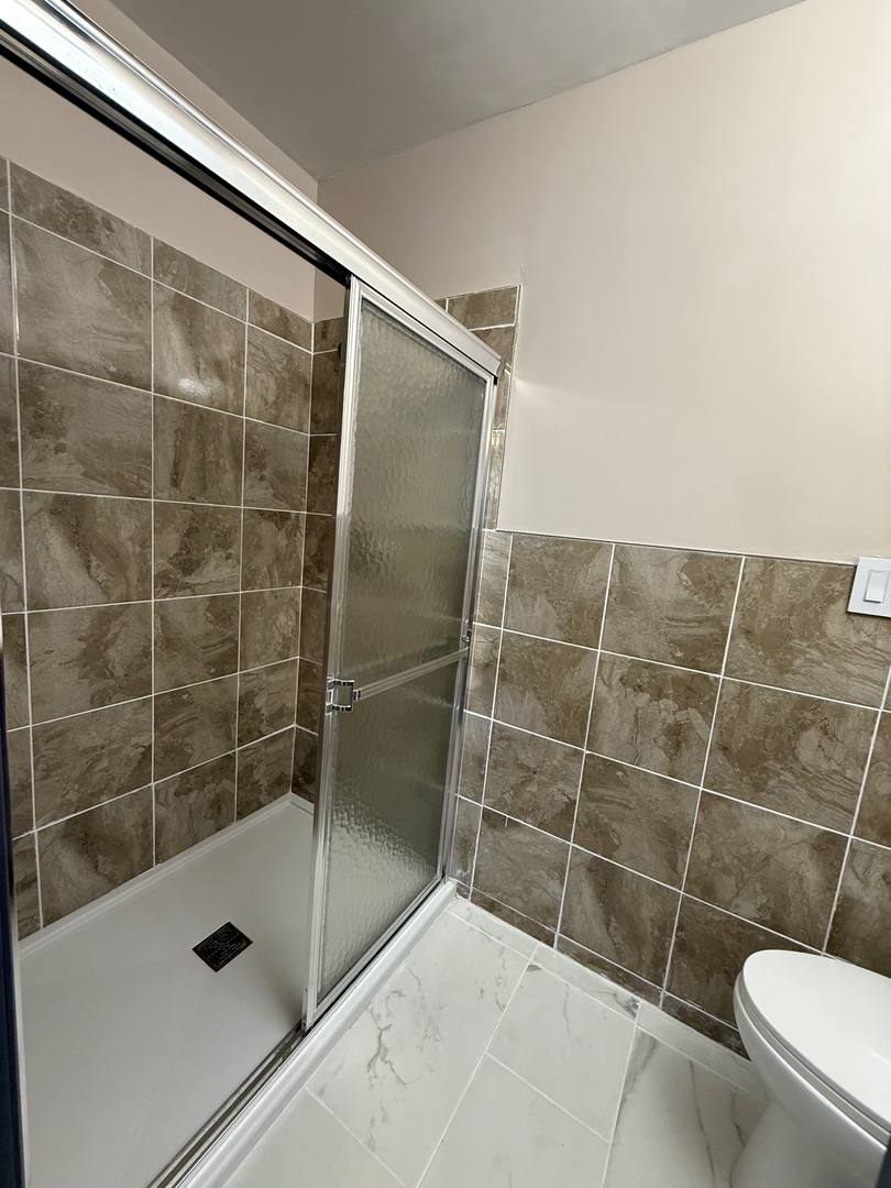 1357 Jeffrey Drive Rantoul, IL 61866 - Photo 15 of 21 a bathroom with a shower and a toilet