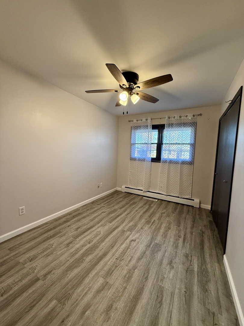 1357 Jeffrey Drive Rantoul, IL 61866 - Photo 16 of 21 an empty room with wooden floor and windows