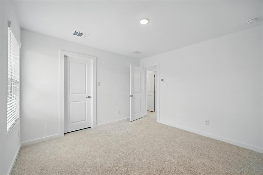 1413 Richardson Street Howe, TX 75459 - Photo 25 of 30 Neutral carpeted room with white walls, a single window with blinds, and recessed lighting