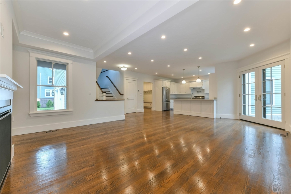 28 Sumner Street, Unit 28 Newton, MA 02459 - Photo 11 of 32 a view of an empty room with a window and wooden floor