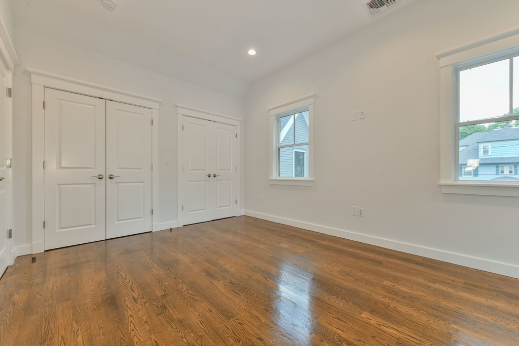 28 Sumner Street, Unit 28 Newton, MA 02459 - Photo 18 of 32 a view of an empty room with wooden floor and a window