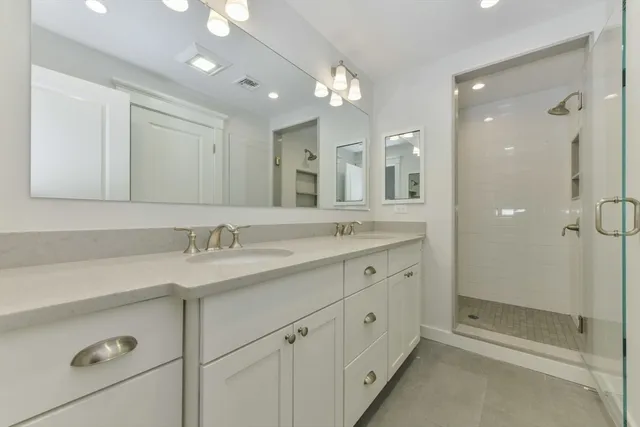 a bathroom with a granite countertop sink mirror and double