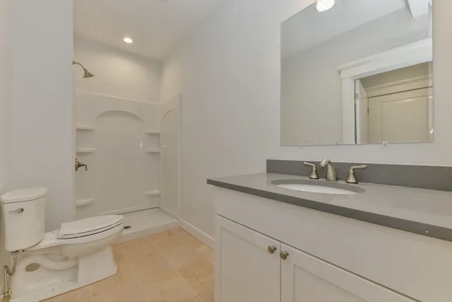 an empty room with a kitchen and entryway