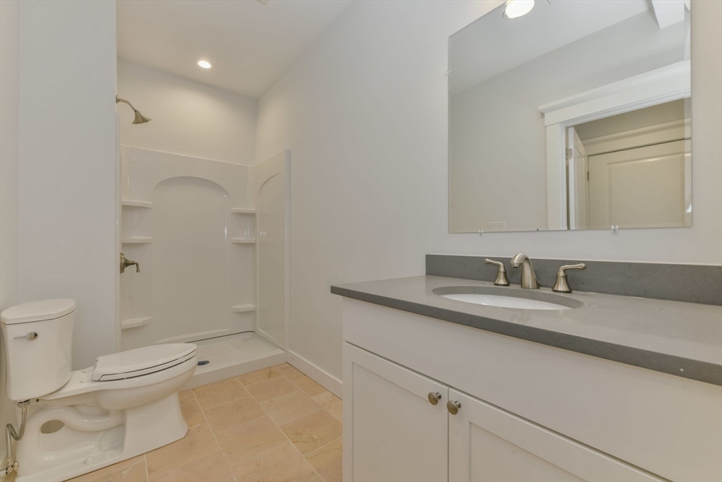 28 Sumner Street, Unit 28 Newton, MA 02459 - Photo 21 of 32 a bathroom with a granite countertop sink mirror vanity and toilet