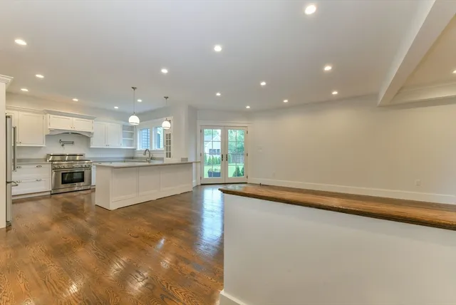 a view of kitchen with kitchen island sink and center island