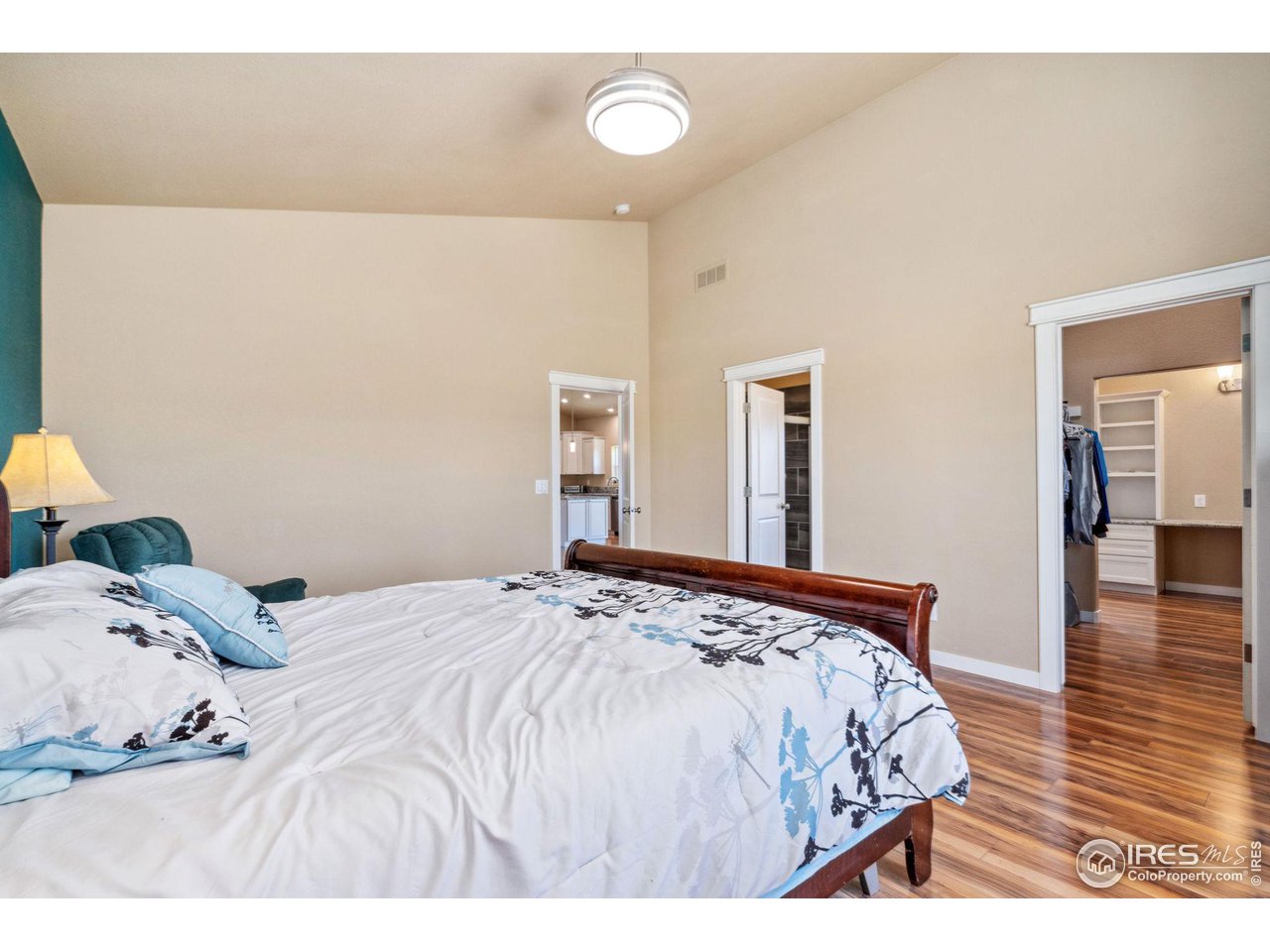 19672 Rawhide Flats Road Wellington, CO 80549 - Photo 14 of 35 Primary bedroom looking towards primary bath and walk-thru closet access