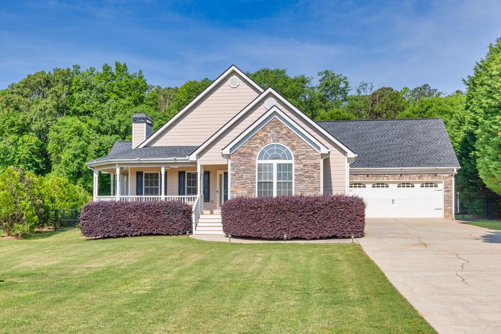 a front view of a house with garden
