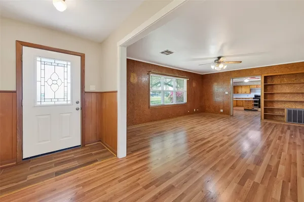 wooden floor fireplace and windows in an empty room