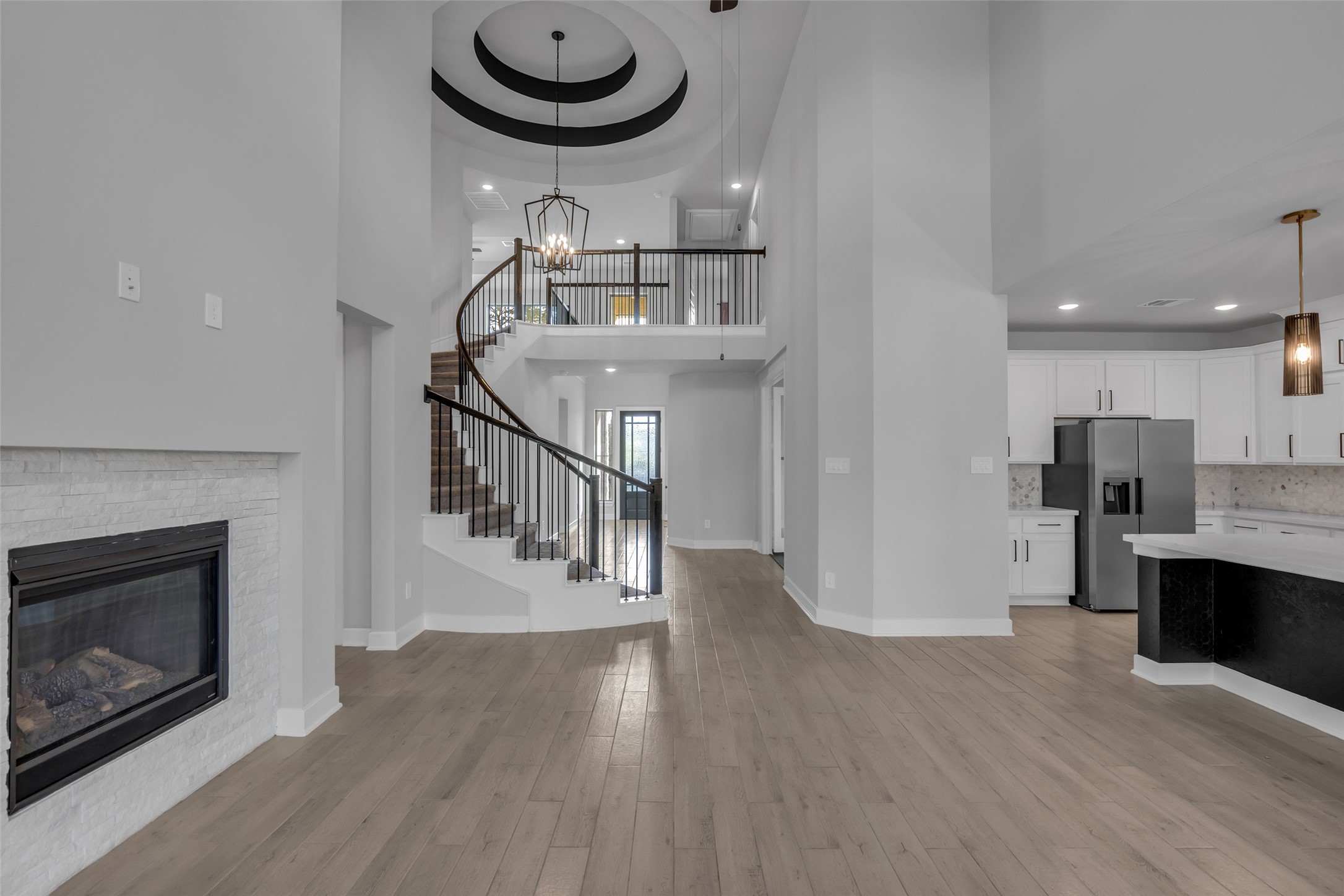 215 Flower Moon Court Conroe, TX 77318 - Photo 10 of 44 a view of dining room with furniture a fireplace and wooden floor