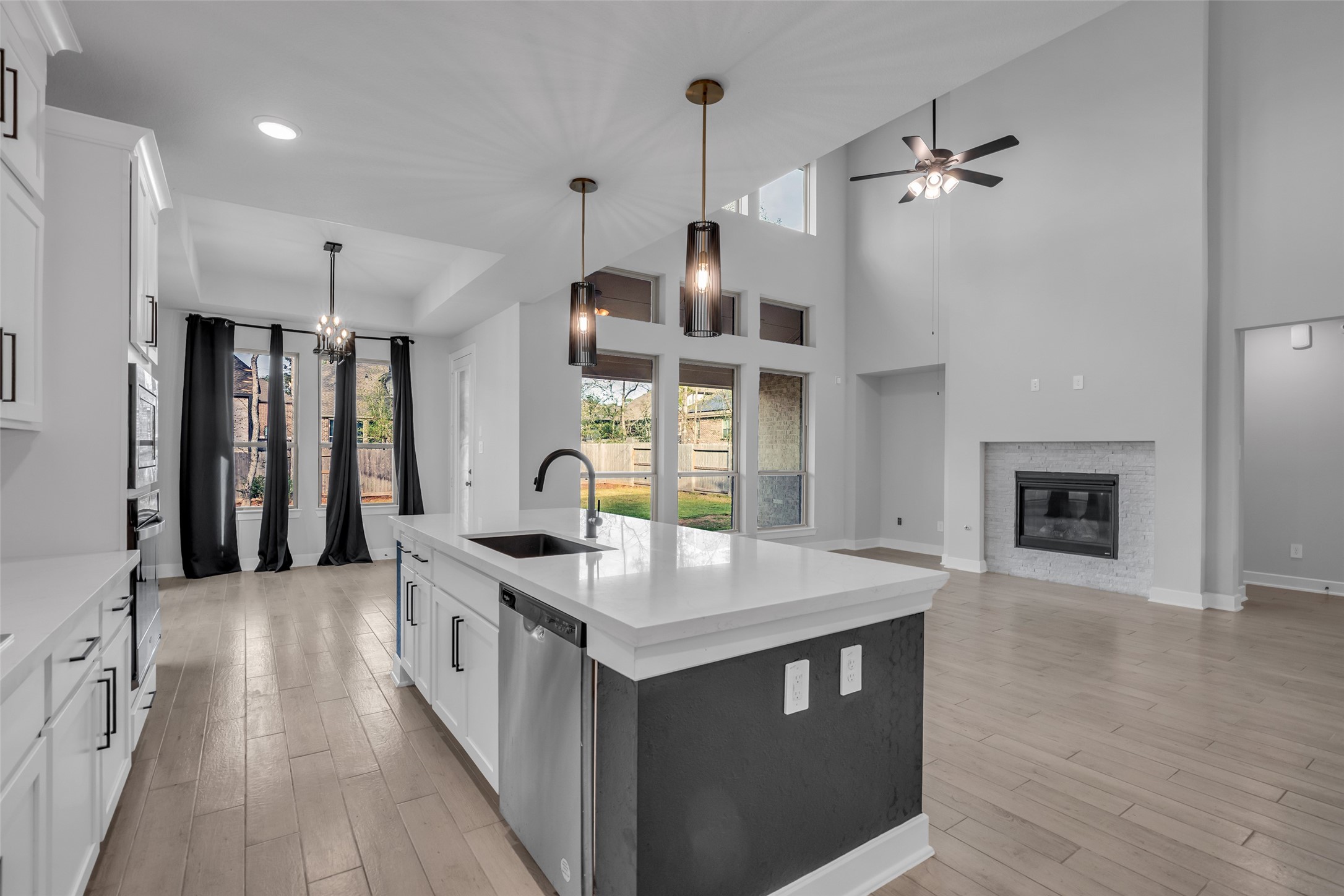 215 Flower Moon Court Conroe, TX 77318 - Photo 11 of 44 a kitchen with stainless steel appliances granite countertop a sink stove and cabinets