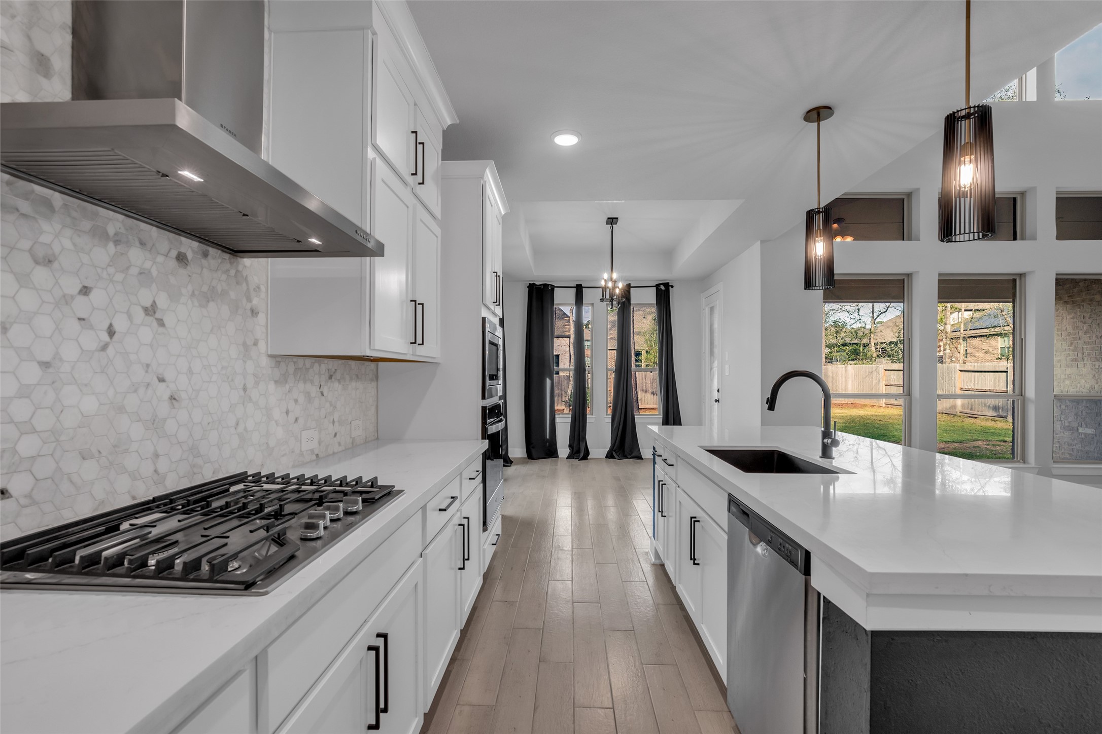 215 Flower Moon Court Conroe, TX 77318 - Photo 12 of 44 a kitchen with granite countertop a sink a stove and refrigerator