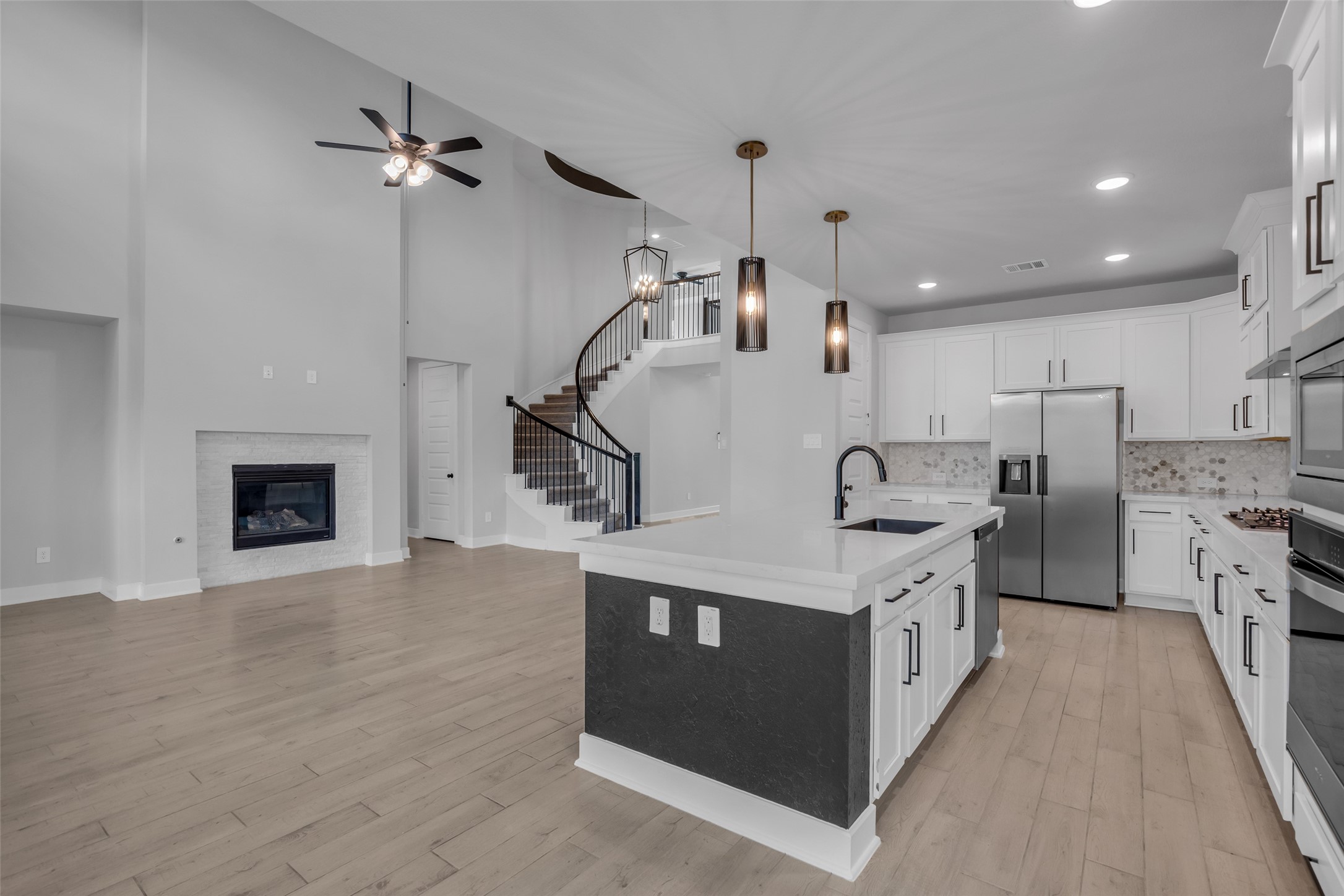 215 Flower Moon Court Conroe, TX 77318 - Photo 13 of 44 a kitchen with a stove and a wooden floors