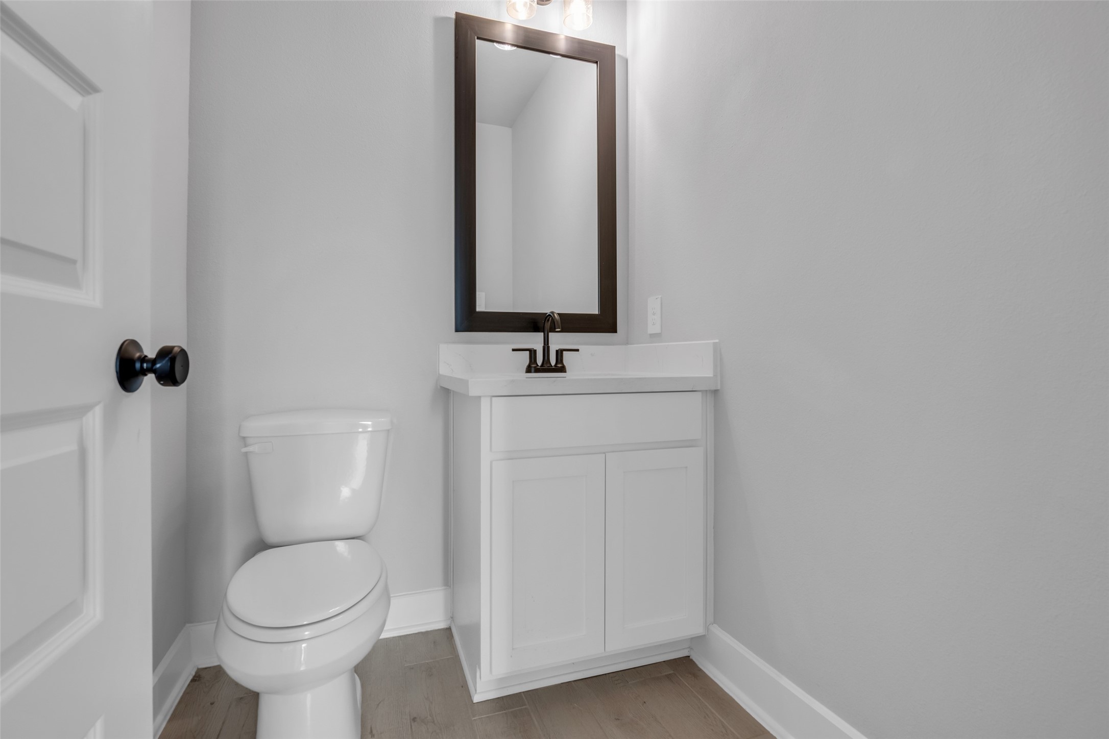 215 Flower Moon Court Conroe, TX 77318 - Photo 17 of 44 a bathroom with a toilet sink and mirror