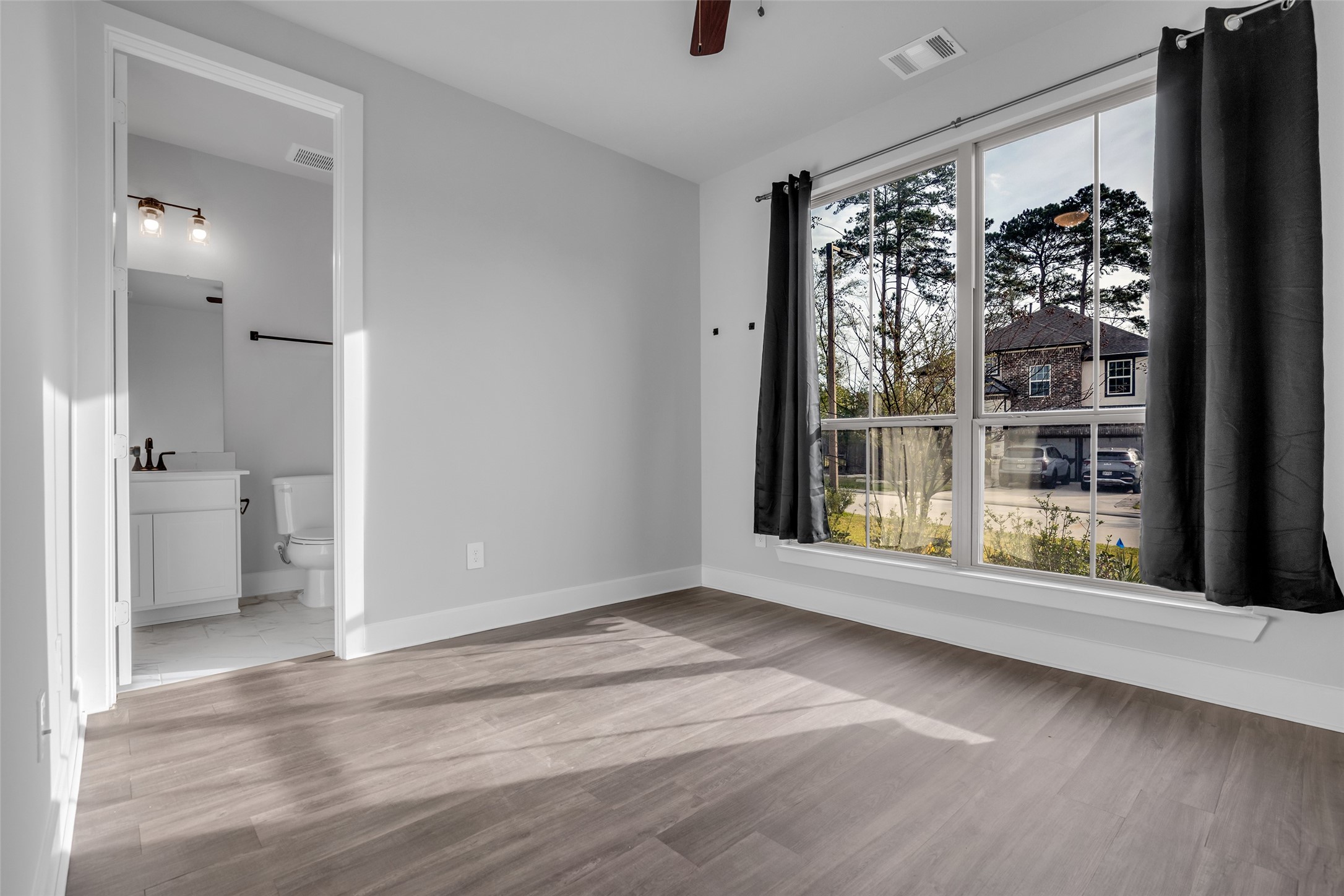 215 Flower Moon Court Conroe, TX 77318 - Photo 18 of 44 a view of empty room with wooden floor and fan