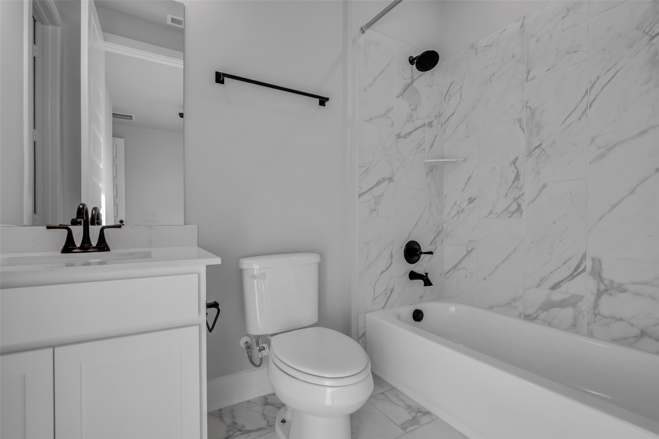 215 Flower Moon Court Conroe, TX 77318 - Photo 19 of 44 a bathroom with a sink a toilet and a bathtub