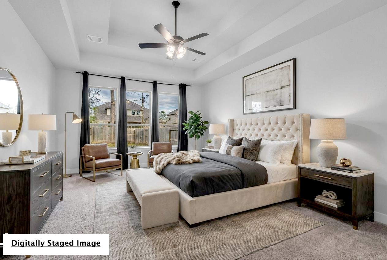 215 Flower Moon Court Conroe, TX 77318 - Photo 21 of 44 a spacious bedroom with a large bed and a chandelier