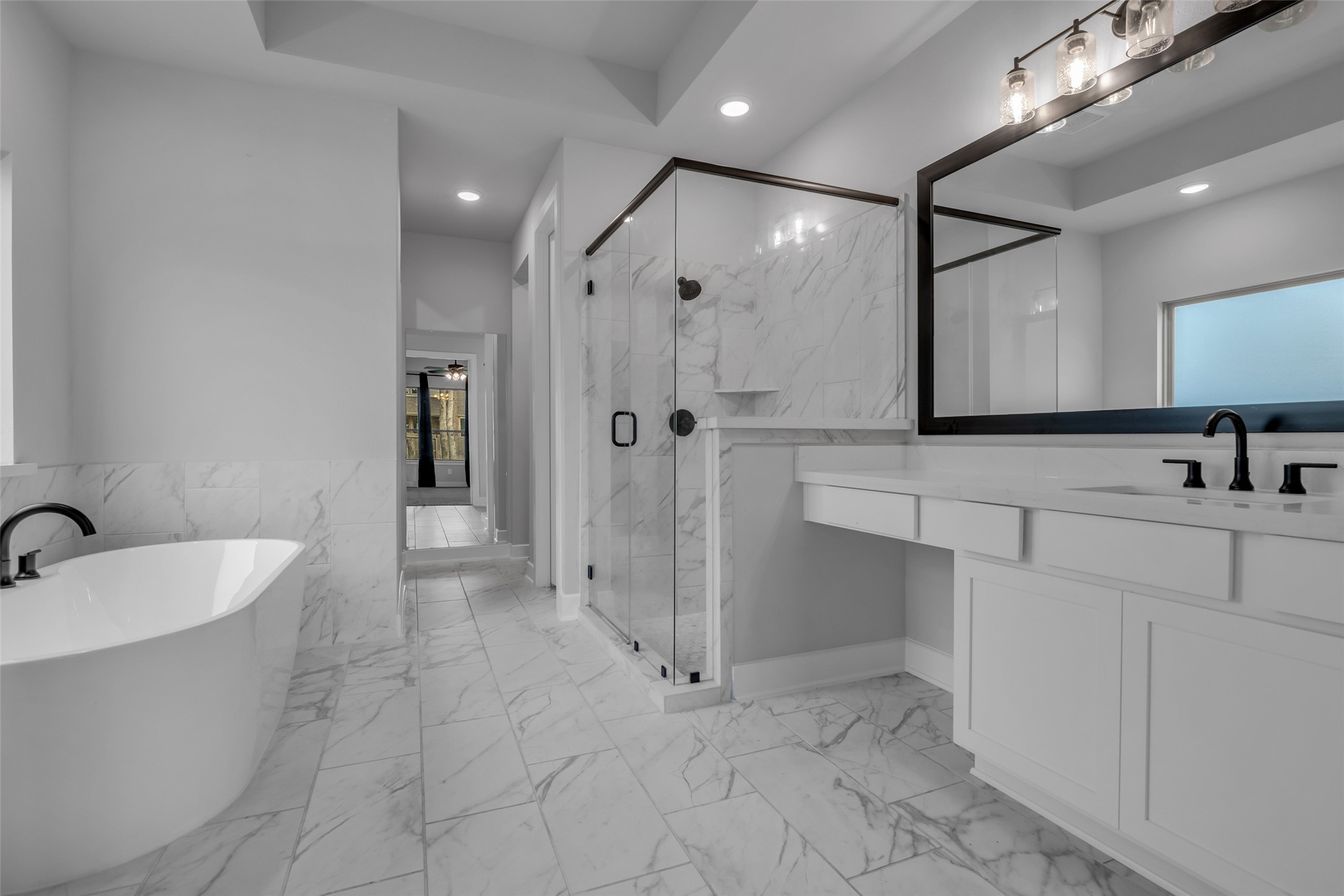 215 Flower Moon Court Conroe, TX 77318 - Photo 22 of 44 a bathroom with a double vanity sink mirror and shower