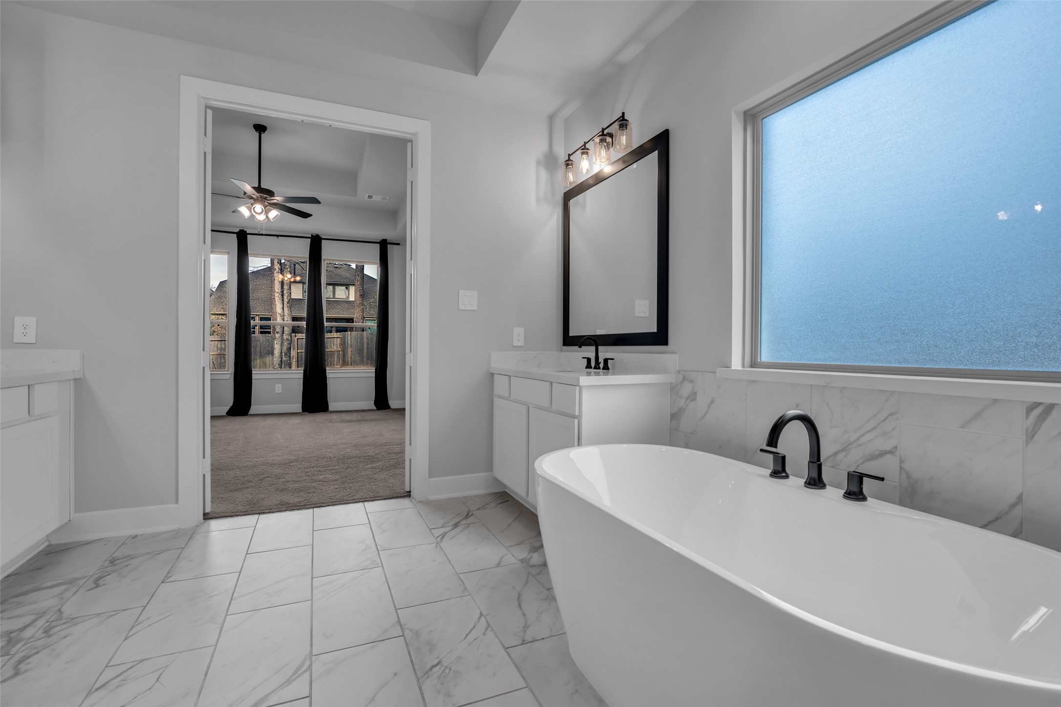 215 Flower Moon Court Conroe, TX 77318 - Photo 23 of 44 a bathroom with a bathtub and a sink