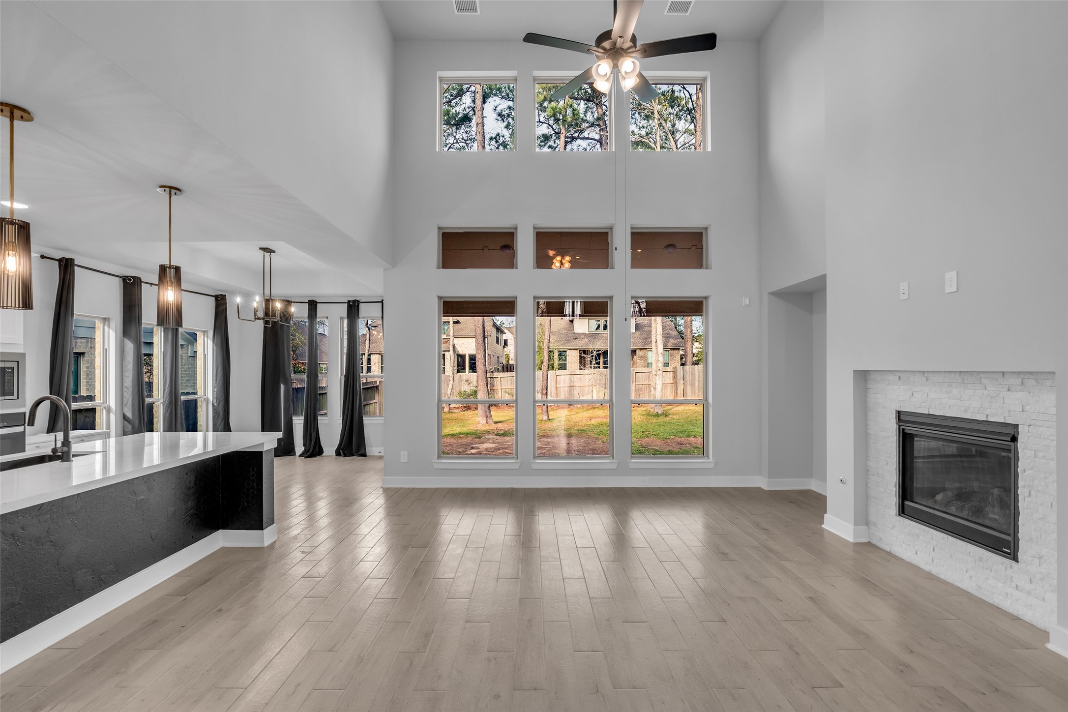 215 Flower Moon Court Conroe, TX 77318 - Photo 44 of 44 an empty room with wooden floor fireplace and windows