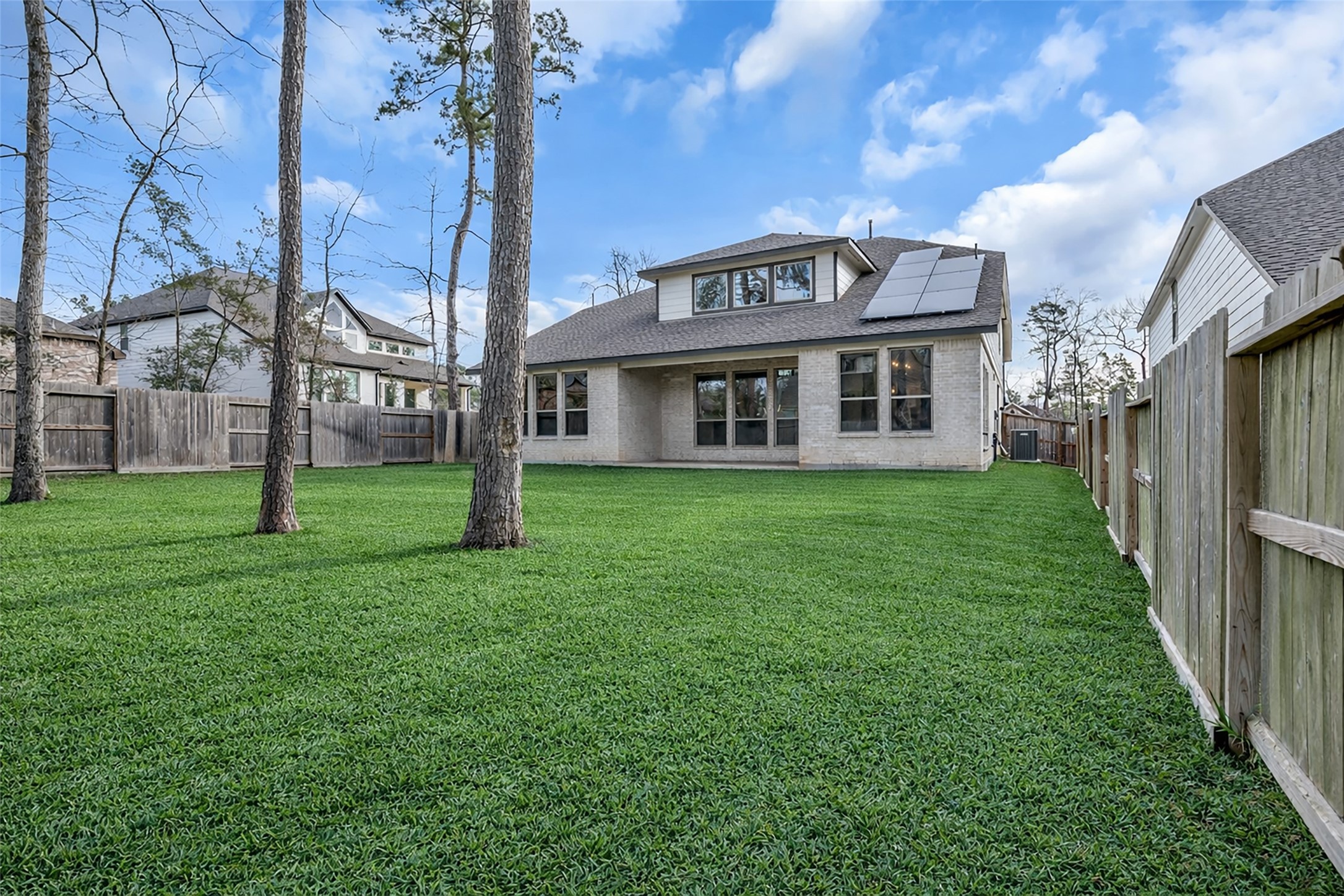 215 Flower Moon Court Conroe, TX 77318 - Photo 34 of 44 a view of a house with backyard and garden