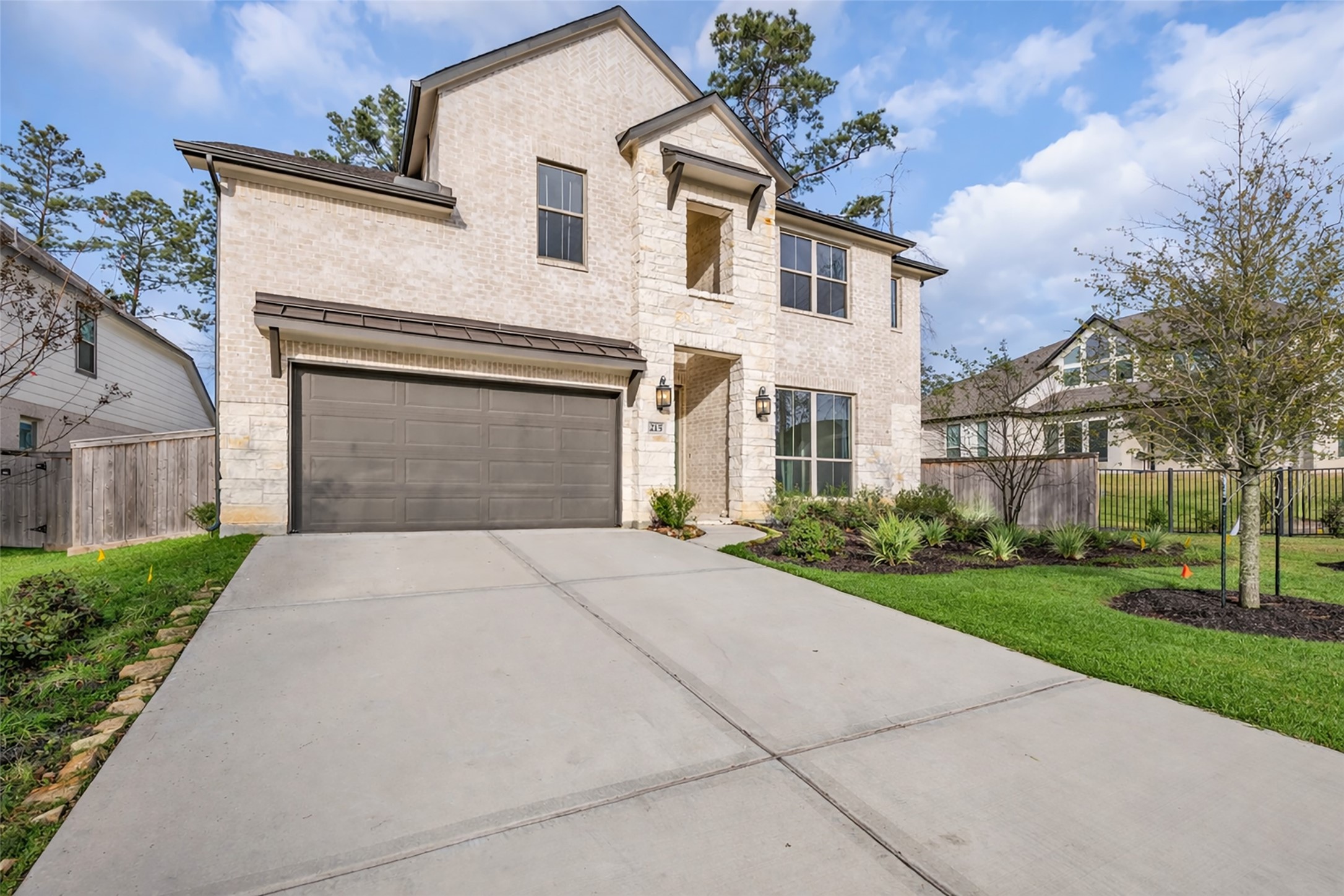 215 Flower Moon Court Conroe, TX 77318 - Photo 36 of 44 a front view of a house with a yard and garage