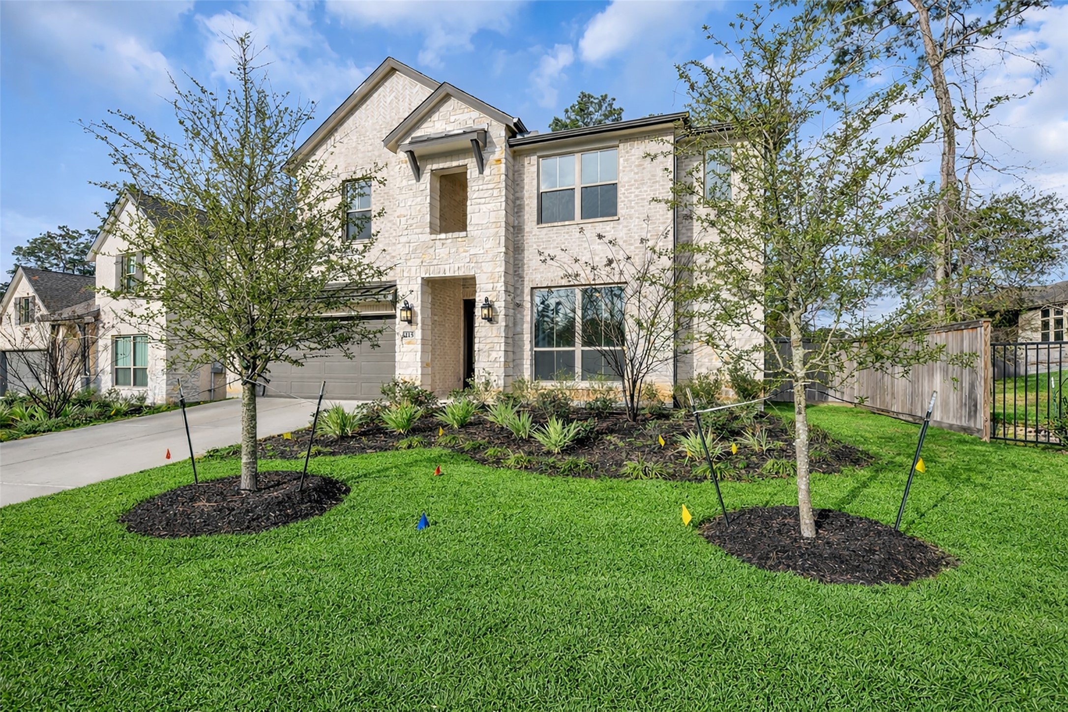 215 Flower Moon Court Conroe, TX 77318 - Photo 37 of 44 a front view of a house with a garden and plants