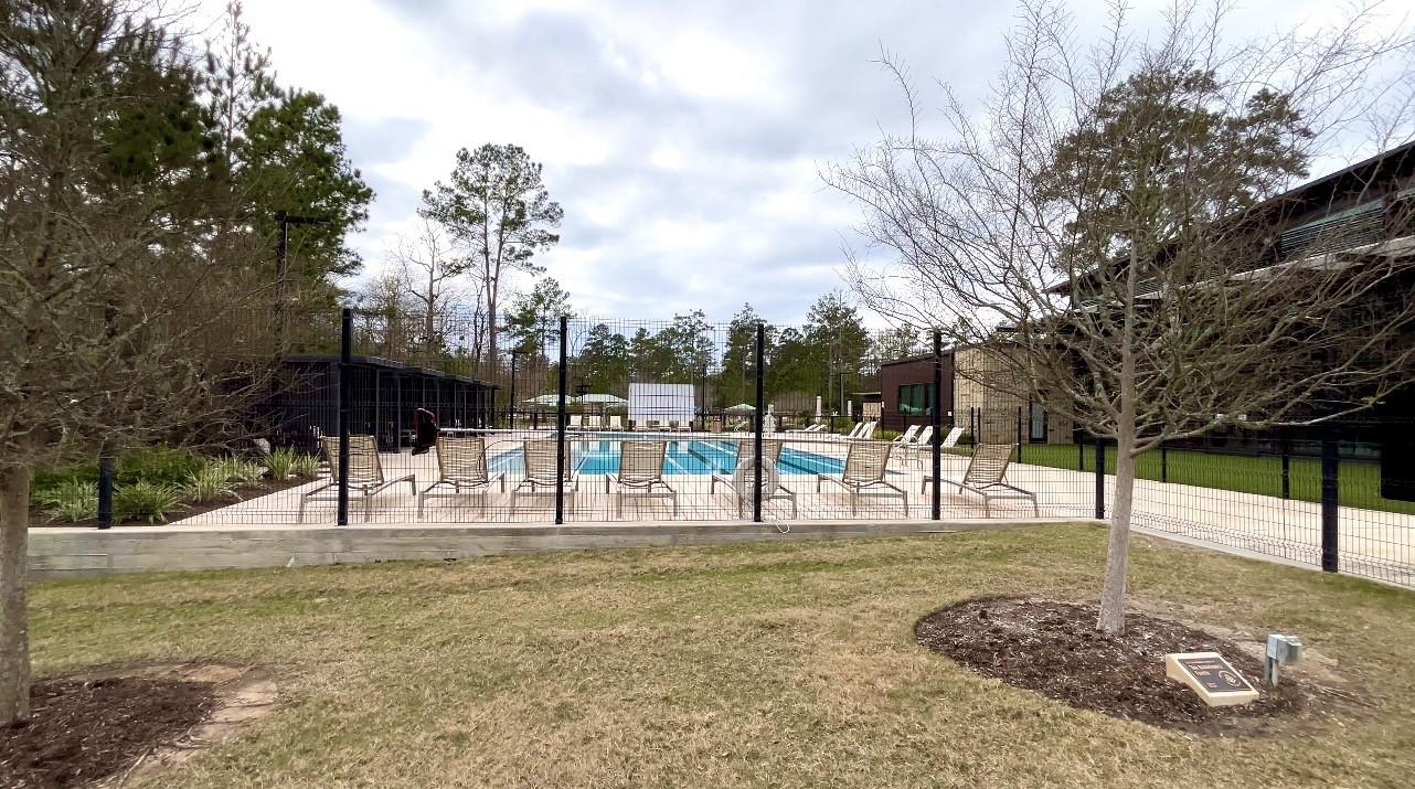 215 Flower Moon Court Conroe, TX 77318 - Photo 42 of 44 a view of a park with swings