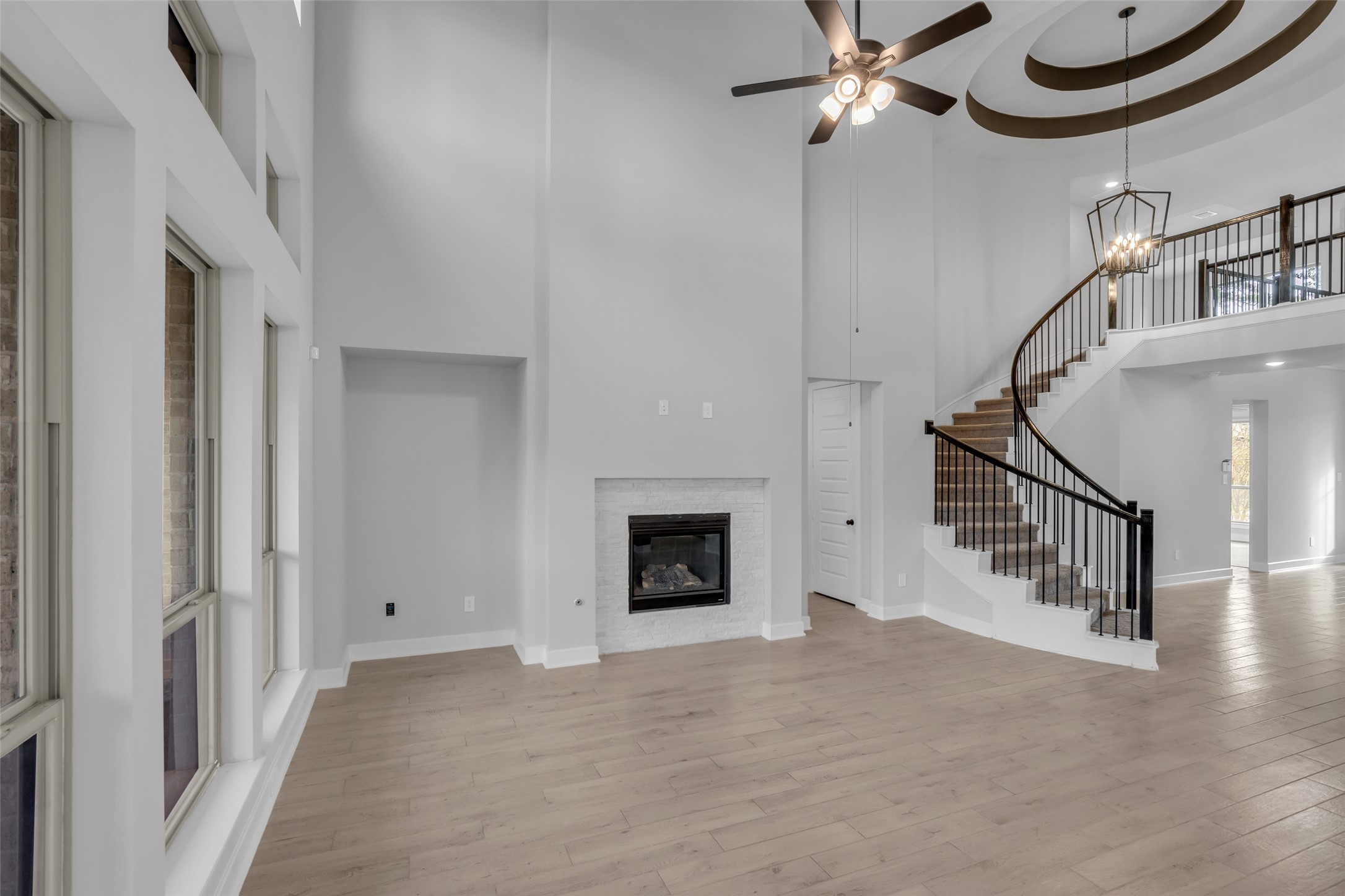 215 Flower Moon Court Conroe, TX 77318 - Photo 5 of 44 a view of entryway and hall with a chandelier fan