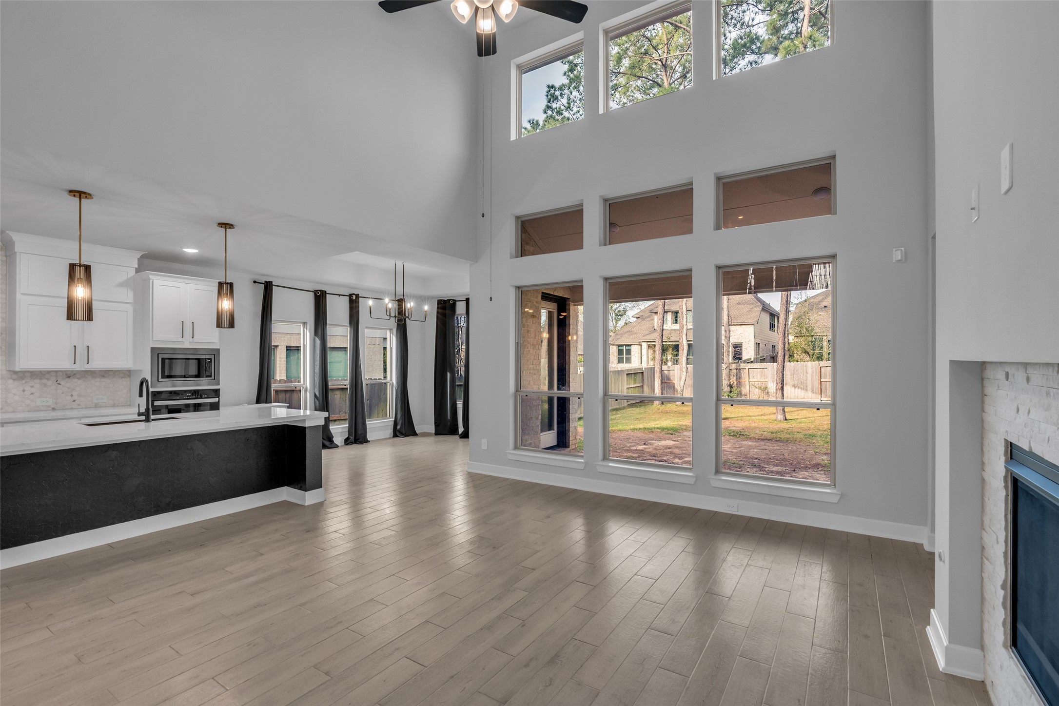215 Flower Moon Court Conroe, TX 77318 - Photo 9 of 44 a large hall with stainless steel appliances wooden floor and a large window