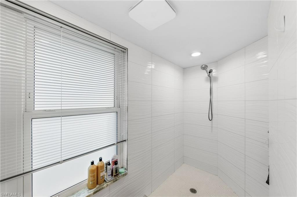 4724 Riverside Drive Estero, FL 33928 - Photo 19 of 44 a bathroom with a shower and a bathtub