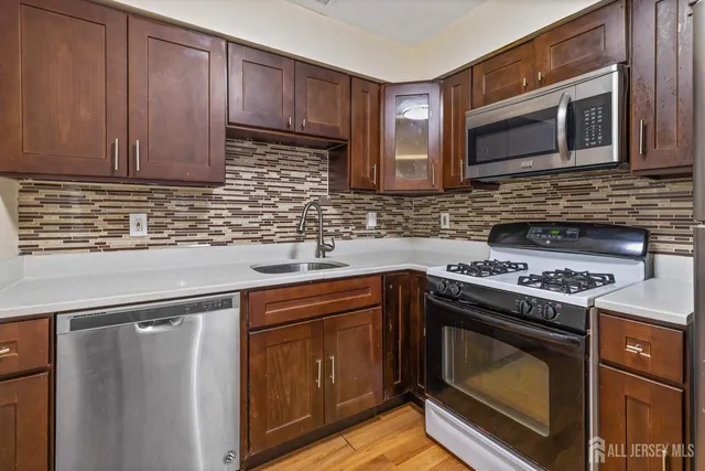 a kitchen with granite countertop cabinets stainless steel appliances and wooden cabinets