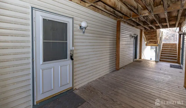 a view of a porch with wooden floor