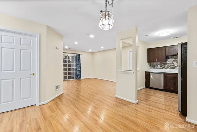 a view of kitchen with sink microwave and refrigerator