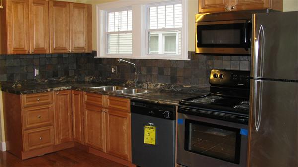 151 Shawmut Street Springfield, MA 01108 - Photo 5 of 12 a kitchen with a stove and a microwave