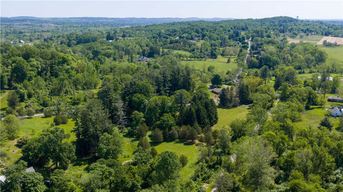 Coldsprings Rd Union Pottstown, PA 19465 - Photo 9 of 71 An aerial perspective reveals a verdant landscape with scattered homes and winding roads through mature trees and open fields.