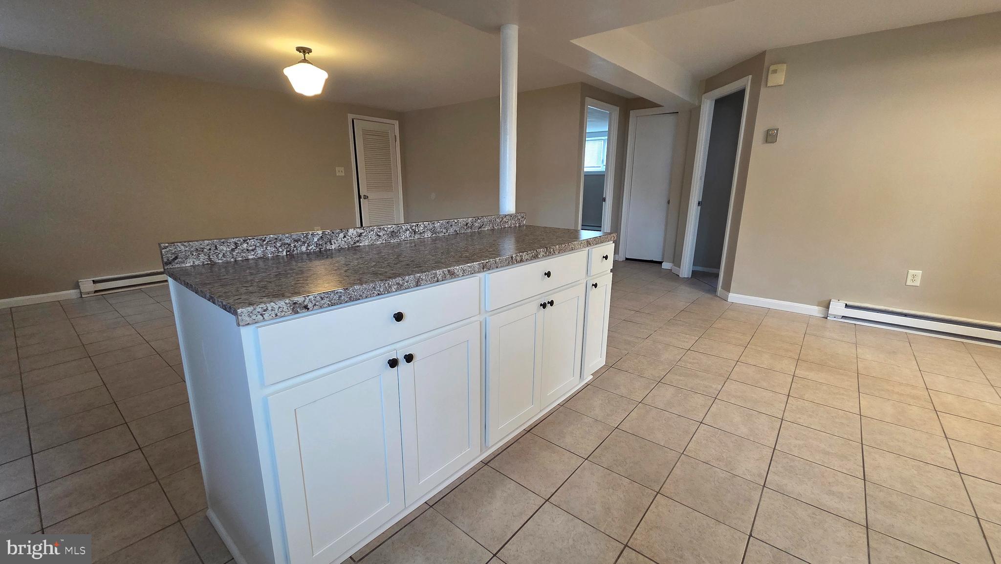 4400 4th Street Baltimore, MD 21225 - Photo 11 of 25 a bathroom with a granite countertop sink and a mirror
