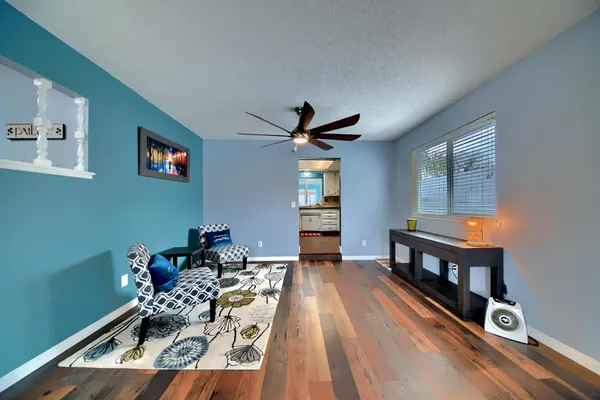 a kitchen with a sink cabinets and wooden floor