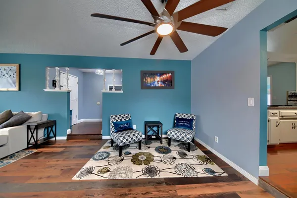 a dining room with furniture a rug and a painting