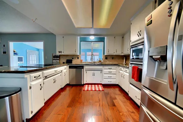 a kitchen with a table and chairs in it