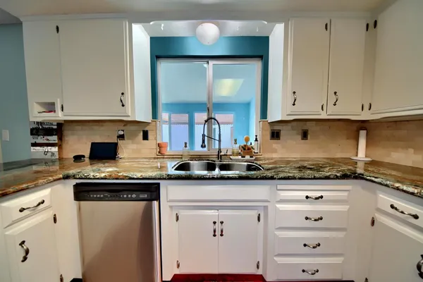 a bathroom with a double vanity sink mirror and shower