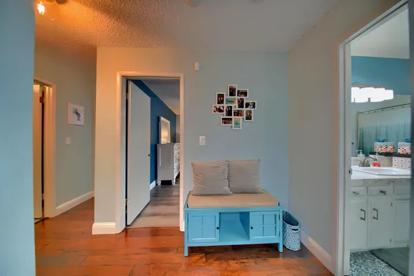 a bedroom with furniture and a wooden floor